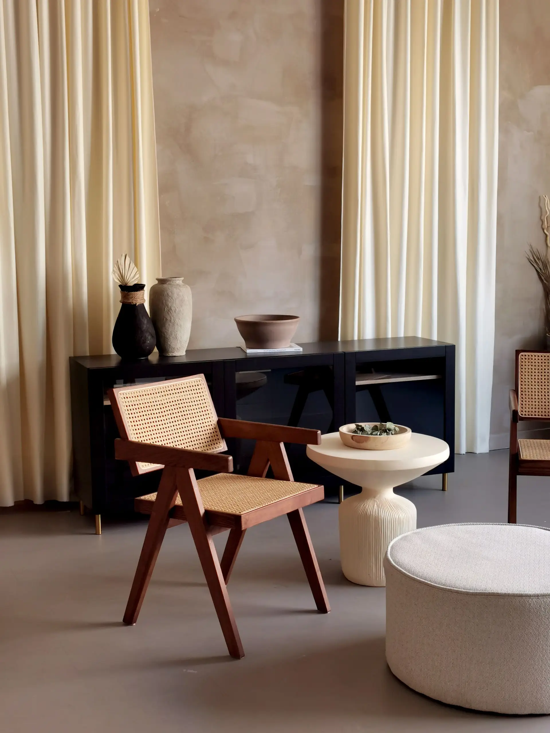 Light-filled modern New Zealand interior studio featuring timber seating, natural woven rugs, and serene earthen warmth