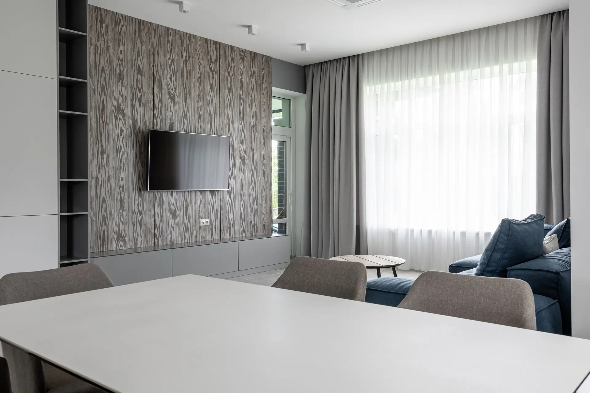 Contemporary New Zealand living room with timber joinery and warm linen upholstery
