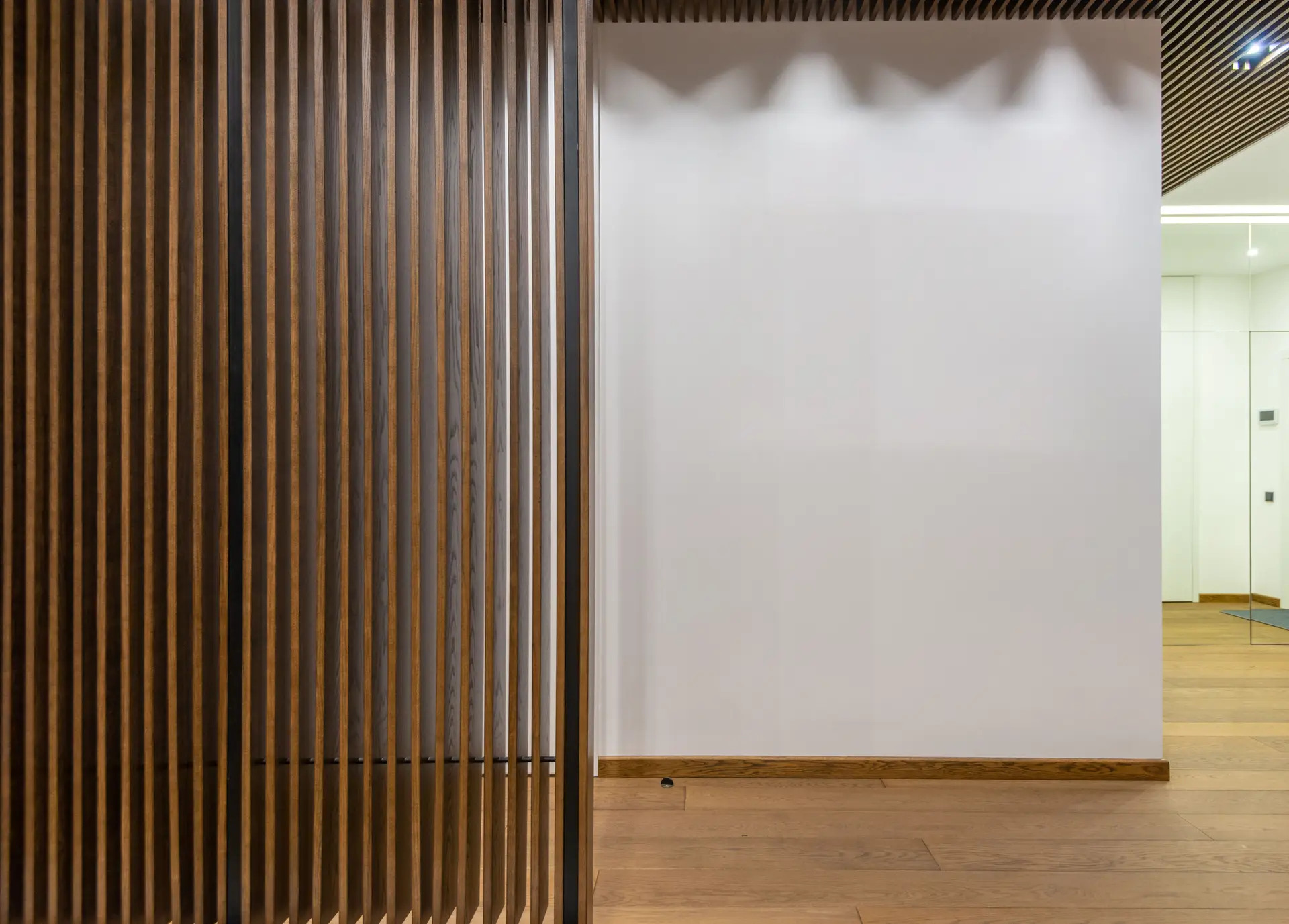 Clarivellessora architectural interior with natural timber partitions and soft lighting